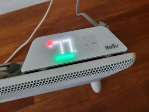 Top control panel of a Ballu heater displaying 77°F, with Wi-Fi and mode controls and status indicator lights