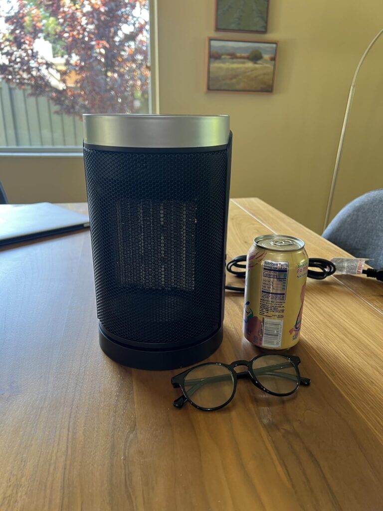 WINHL ceramic space heater on a desk — real-world size next to a soda can and glasses