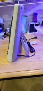 Side view of Sonbion infrared radiant heater showing the kickstand, slim profile, and attached power cord on a workbench