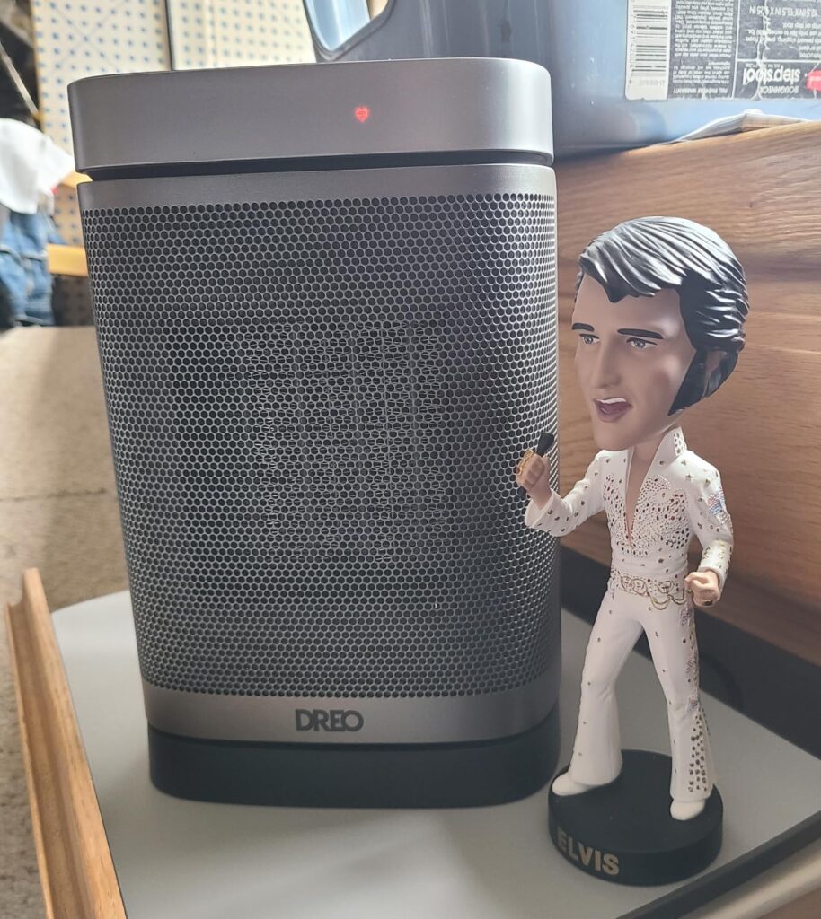 Dreo Atom One space heater next to an Elvis figurine for real-life size comparison