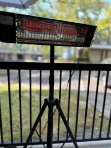 Side view of Paraheeter QHA-15DB infrared heater on tripod, angled downward for targeted heat