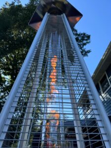 Low-angle close-up of the FOOWIN quartz glass tube pyramid patio heater with the flame burning inside