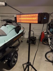 Paraheeter QHA-15DB infrared heater in a garage, glowing element with H1 heat setting