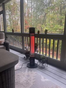 HAIMMY UEH520 infrared patio heater warming a screened-in porch with a wooded view outside