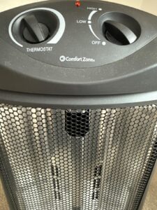 Top controls on Comfort Zone halogen heater showing thermostat knob and low high heat settings