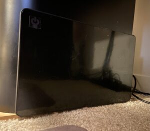 Cozy Products Cozy Legs CL-2 flat panel heater placed on carpet beside a desk