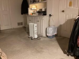 Comfort Zone CZ7007J oil-filled radiator heater warming a bedroom with carpeted floor and built-in cabinets