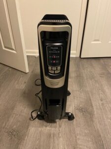PELONIS PH-14A oil-filled radiator heater standing on caster wheels with LED controls